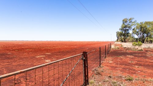 Red dirt over the farm land for as far as the eye can see