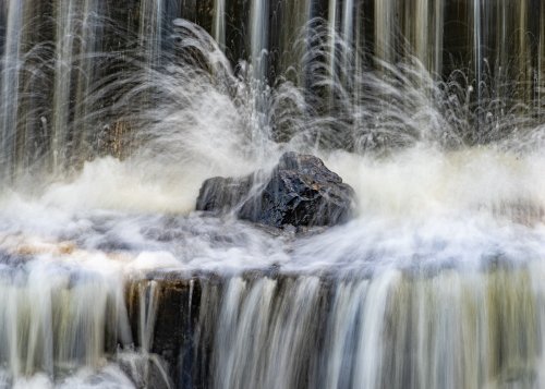 Water splashing over a rock